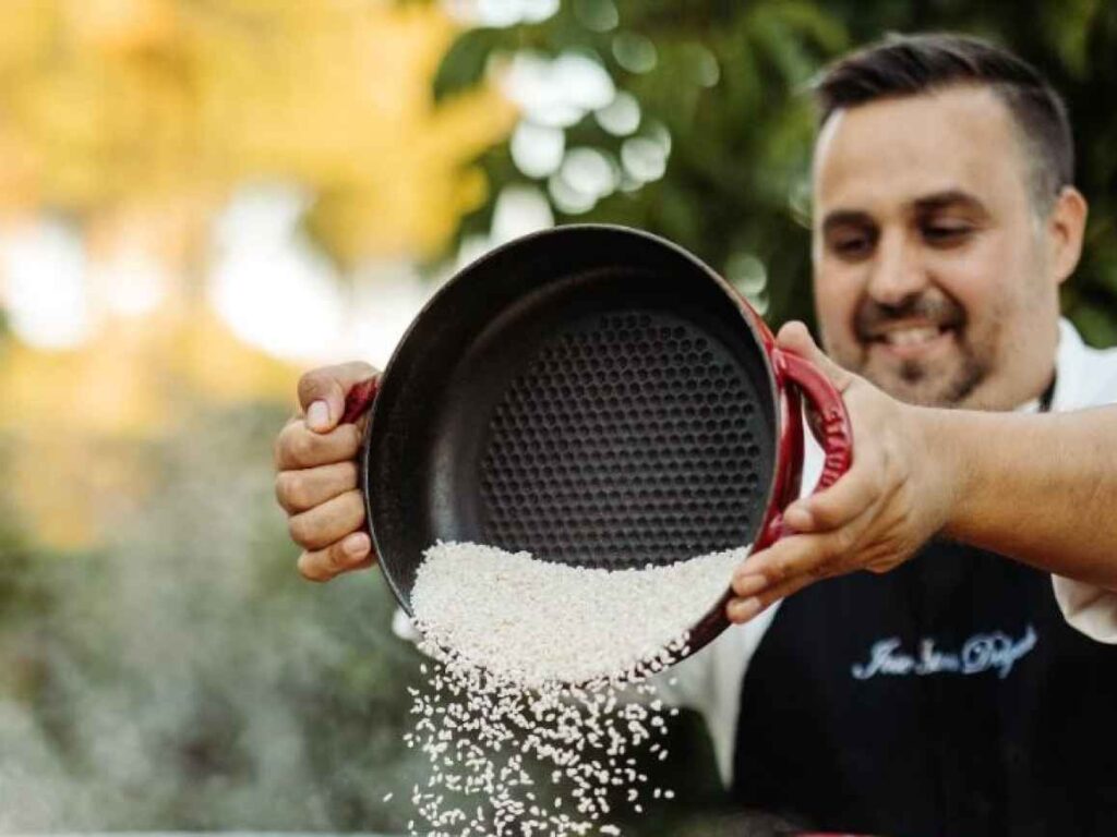 Chef Jose tossing rice in his cooking bowl.